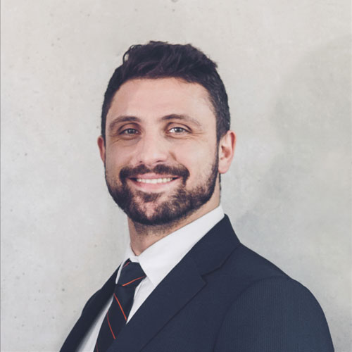 Jonathan Taylor, a licensed Psychologist at Serenity Grove Mental Health, smiles in a professional headshot wearing a suit and tie.