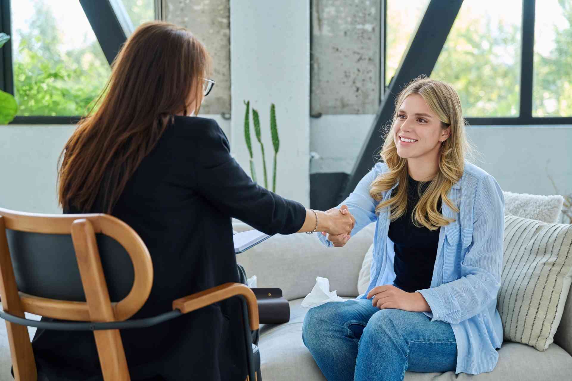 Therapist and patient shaking hands during a dual diagnosis therapy session