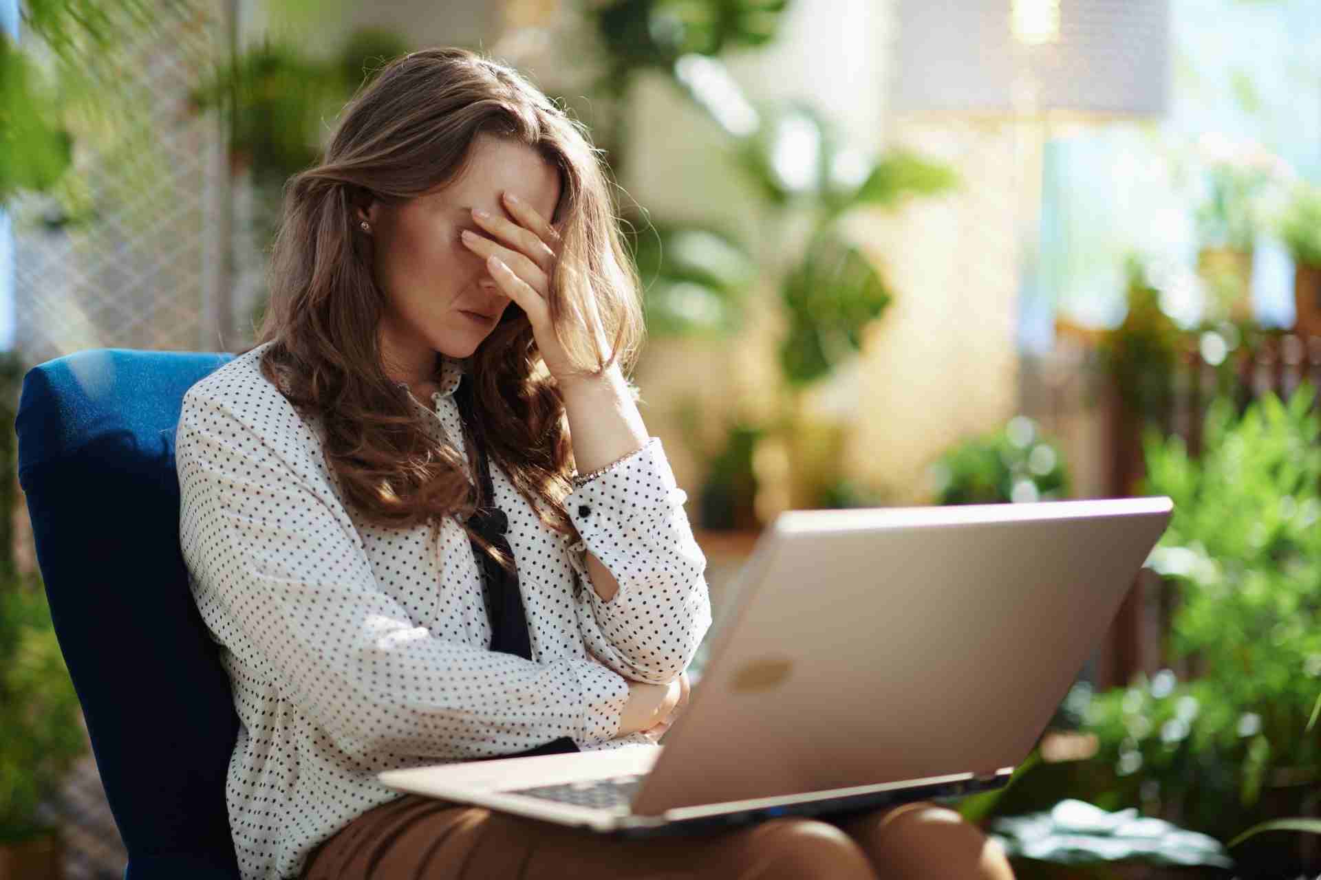 Person experiencing emotional exhaustion and functional depression while working on a laptop