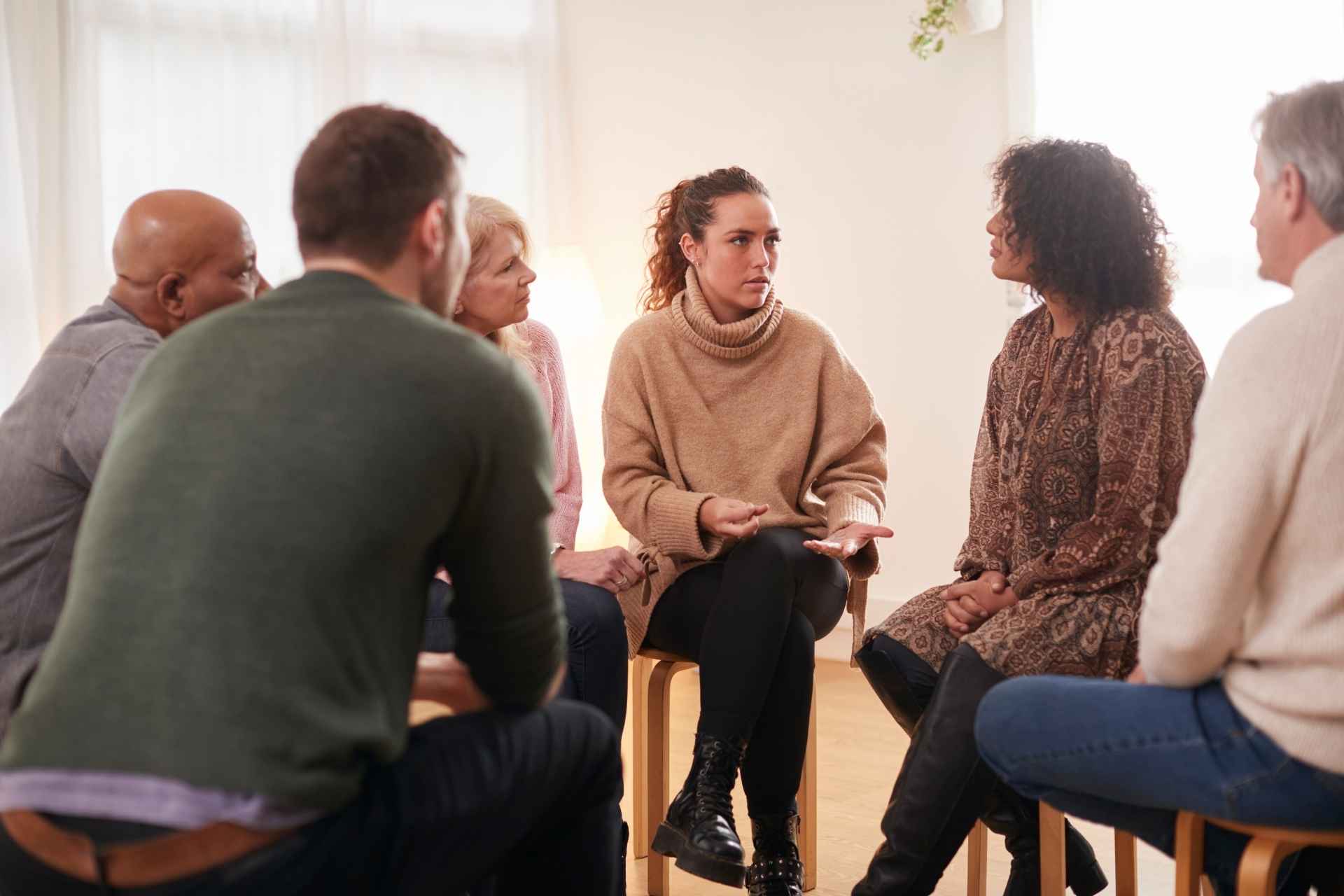 Adults participating in a supportive mental health group therapy session.